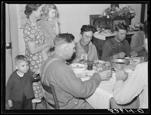 Untitled photo, possibly related to: Mrs. Fred Wilkins passing cake to the men at dinner on corn-shucking day. Tallyho, Stem, Granville County, North Carolina