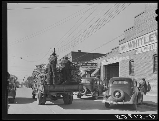 Truckload of tobacco in baskets being taken from the warehouse after the auction sales down the main street of Wendell. Wake County, North Carolina