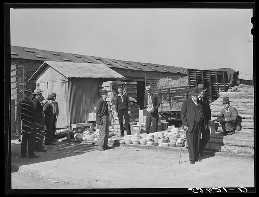Untitled photo, possibly related to: Farmers buying china from salesman outside tobacco warehouse during sales. Wendell, North Carolina