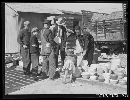 Farmers buying china from salesman outside tobacco warehouse during sales. Wendell, North Carolina