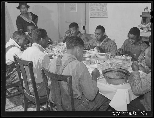 The Negro tenants and neighbors eating dinner after the white men have finished on day of corn-shucking at Mrs. Fred Wilkins' home. Tallyho, Stem, Granville County, North Carolina