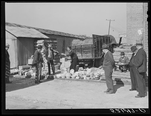 Untitled photo, possibly related to: Farmers buying china from salesman outside tobacco warehouse during auction sales. Wendell, North Carolina