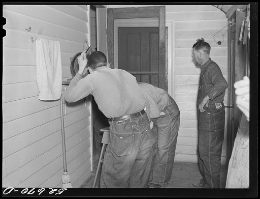Farmers washing up before dinner on porch of Mrs. Fred Wilkins' home on cornshucking day at Tallyho, near Stem. Granville County, North Carolina
