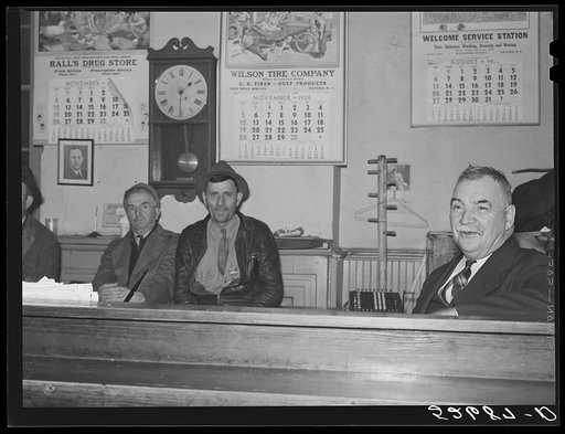 Sheriff Graham and two farmers killing time during dinner hour in his office on court day in Granville County Courthouse. Oxford, North Carolina