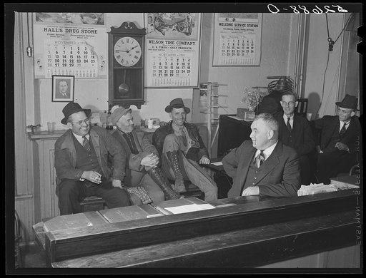 Sheriff Graham and two farmers killing time during dinner hour in his office on court day in Granville County Courthouse. Oxford, North Carolina
