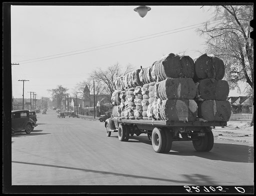 Truckload of bales of cotton on its way through town of Oxford. Granville County, North Carolina