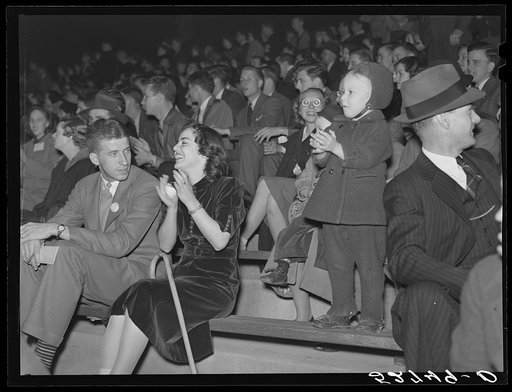 Some University of North Carolina students on their campus in Chapel Hill, Orange County, North Carolina, with their weekend guests and many of the townspeople at a pep rally the night before the Duke-North Carolina game, which was played in the Duke Stadium in Durham, North Carolina