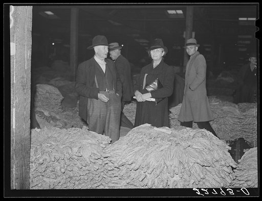 Untitled photo, possibly related to: Auctioneer, buyers, and farmers during tobacco auction sale. Warehouse, Durham, North Carolina