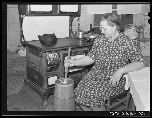 Mrs. Elvin Wilkins (Rosa) churning butter in the kitchen of their home in Tallyho. Near Stem, Granville County, North Carolina. See subregional notes (Odum) November 16, 1939