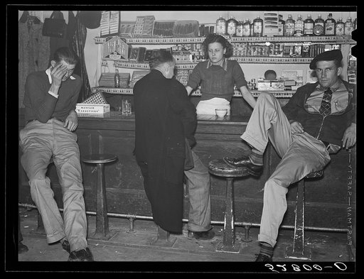 Untitled photo, possibly related to: Farmers must often wait overnight or for several days before their tobacco is sold at auction. They sometimes hang around in cafes or pool rooms, sleeping most anywheres. Durham, North Carolina
