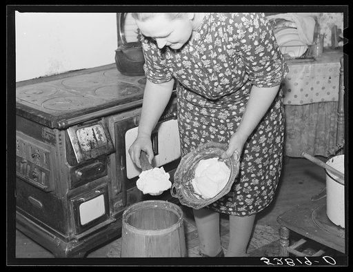 Mrs. Elvin Wilkins (Rosa) churning butter in the kitchen of their home in Tallyho, near Stem, Granville County, North Carolina. See subregional notes (Odum) November 16, 1939