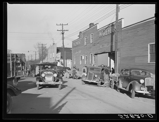 Untitled photo, possibly related to: Farmer taking his tobacco from one warehouse to another for auction sale. Most of the warehouses are very rushed and quickly filled up the first of the week because most farmers think they get a better price on Monday and Tuesday. Mebane, Orange County, North Car