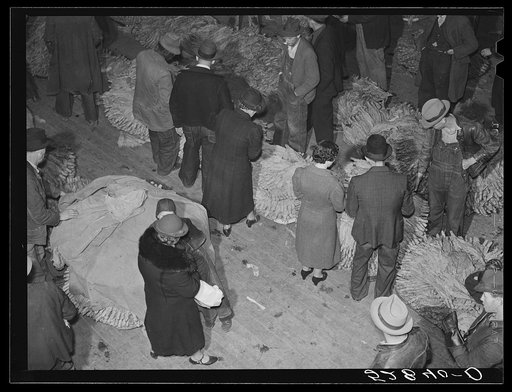 Farmers and their wives in warehouse during tobacco auction. Mebane, Orange County, North Carolina