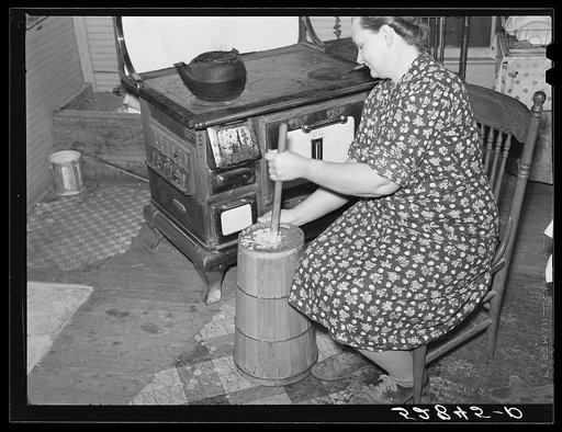 Mrs. Elvin Wilkins (Rosa) churning butter in the kitchen of their home in Tallyho, near Stem, Granville County, North Carolina. See subregional notes (Odum) November 16, 1939