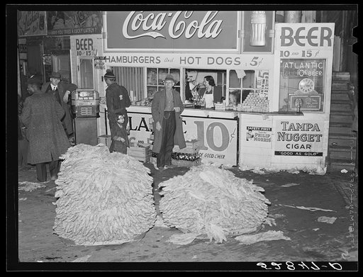 Untitled photo, possibly related to: Lunch stand and tobacco inside entrance to warehouse at end of auction sale. Durham, North Carolina