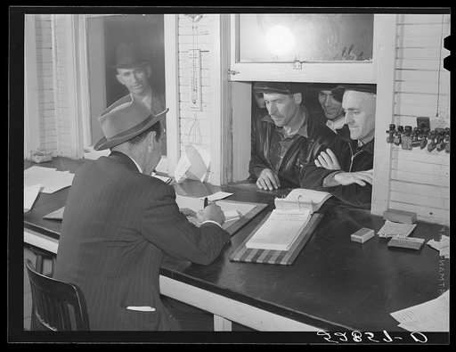Farmers getting their checks in warehouse office after their tobacco has been sold at auction. Durham, North Carolina