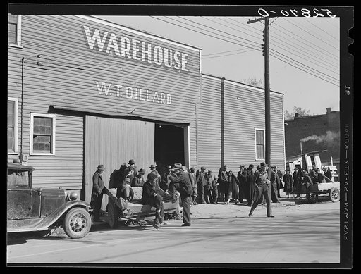 Farmers waiting around and visiting before tobacco auction at warehouse in Mebane, Orange County, North Carolina