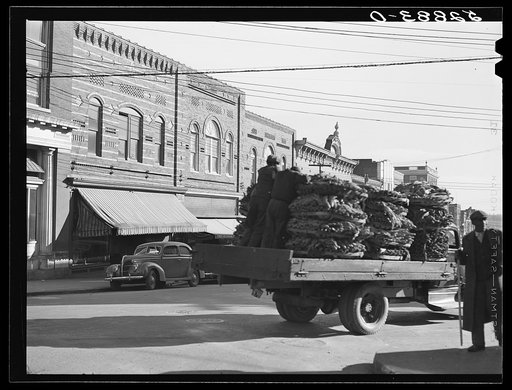 Untitled photo, possibly related to: Tobacco warehouses on main street of South Boston, Halifax County, Virginia. A truck is hauling a load of tobacco after the auction. There are eleven warehouses in this small town