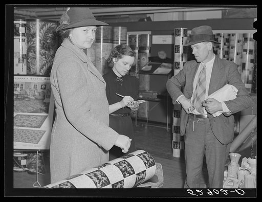 Untitled photo, possibly related to: Mr. and Mrs. Elvin Wilkins (Rosa) discussing whether or not they will buy this linoleum for their kitchen floor. They decided it was too light and not wide enough and that they would wait. They came to Durham, North Carolina from their farm near Stem, Granville C