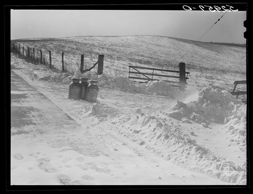 Farmer's milk cans on highway waiting to be picked up by truck near Frederick, Maryland