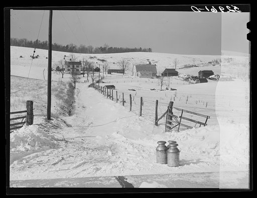 Farmer's milk cans on highway waiting to be picked up by truck near Frederick, Maryland