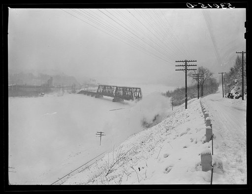 Highway during blizzard with railroad bridge crossing Connecticut River to Brattleboro, Vermont