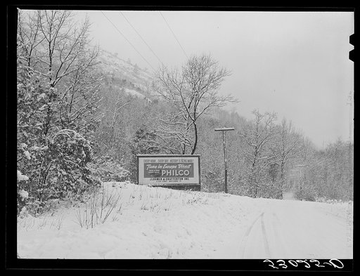 Highway during blizzard near Brattleboro, Vermont. Signboard on highway