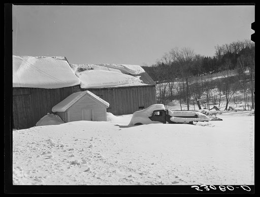 Barn and truck snowed under after storm. Woodstock, Vermont