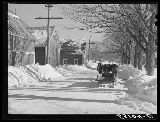 Sled and oxen hauling manure from barn to field. Rupert Lewis dairy farm. Woodstock, Vermont