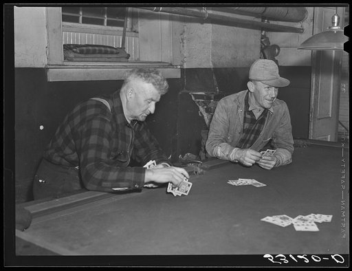 Farmers playing cards in pool room in town on a winter morning in Woodstock, Vermont