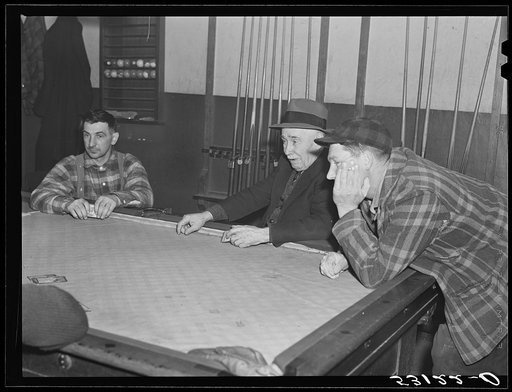 Farmers playing cards in pool room in town on a winter morning. Woodstock, Vermont