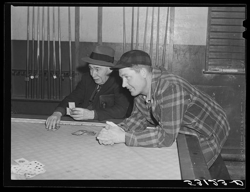 Farmers playing cards in pool room in town on a winter morning in Woodstock, Vermont
