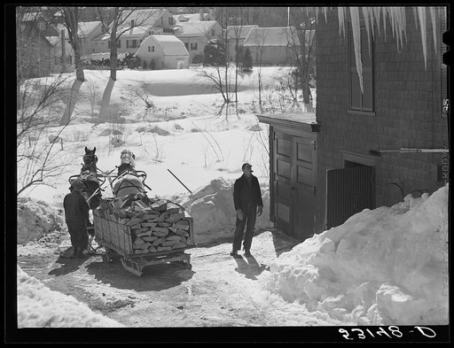 Untitled photo, possibly related to: Unloading stove wood from sled woodshed. Woodstock, Vermont