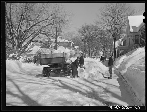 Untitled photo, possibly related to: Clearing the banks of snow along main street in center of town. Woodstock, Vermont