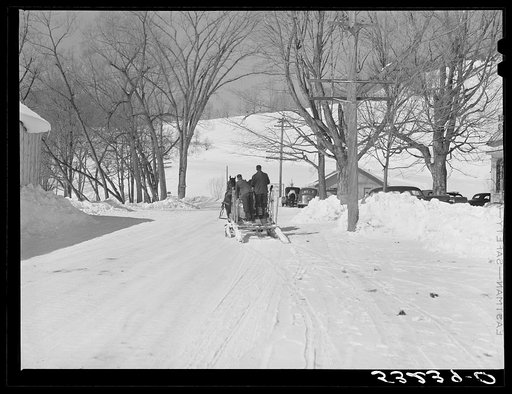 Clinton Gilbert, farmer, and his helper hauling water in milk cans on sled, as their sources of water supply were frozen for two months during very severe winter. Woodstock, Vermont