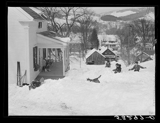 Children having snowball fight in front of their home in Woodstock, Vermont
