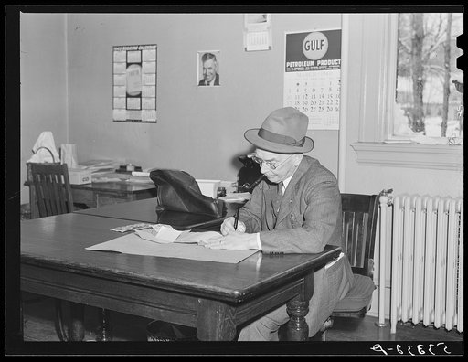 Town treasurer in his office in town hall on day of town meeting. Woodstock, Vermont
