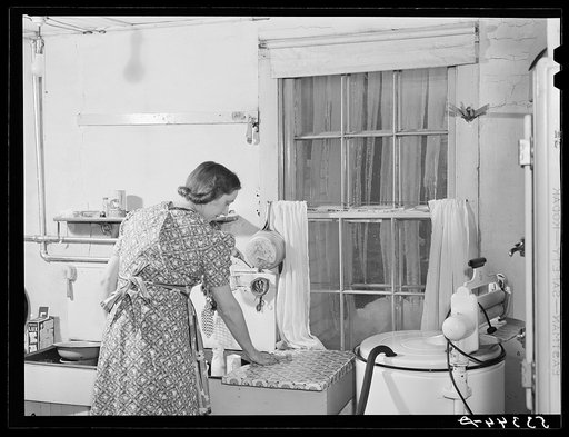A New England housewife fixing supper on winter night. Woodstock, Vermont