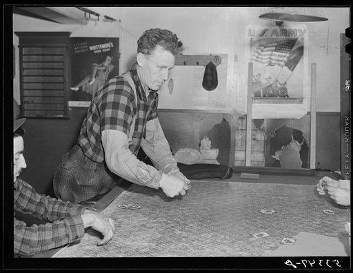Farmer and townspeople have more leisure time to play cards in pool room during winter months. Woodstock, Vermont