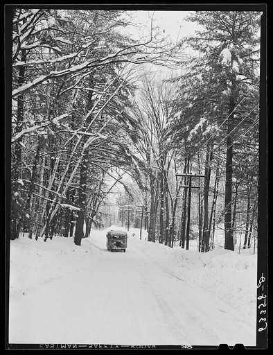 Highway and school bus after storm near North Conway, New Hampshire