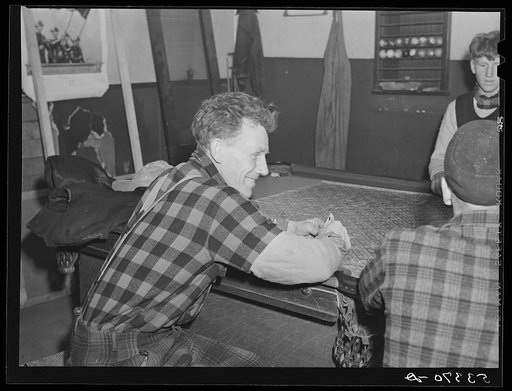 Farmers and townspeople playing cards in pool room on winter morning. Woodstock, Vermont