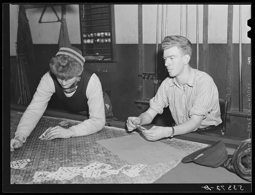 Farmer and townspeople playing cards in pool room on winter morning. Woodstock, Vermont