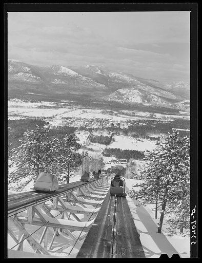 Untitled photo, possibly related to: North Conway, New Hampshire, from Cranmore Mountain. Presidential range of White Mountains in distance. Skiers are taken up to the top by the skimobile. Eastern slopes ski territory