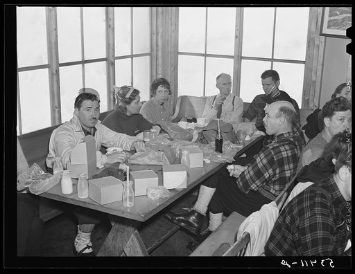 Skiers eating lunch in tollhouse at foot of Mount Mansfield. Smugglers Notch. Near Stowe, Vermont