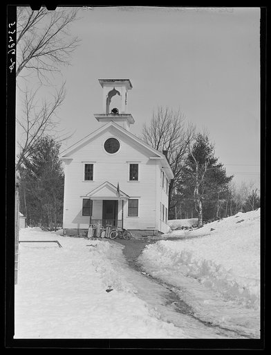 School with children's sleds and skies parked outside Center Sandwich, New Hampshire