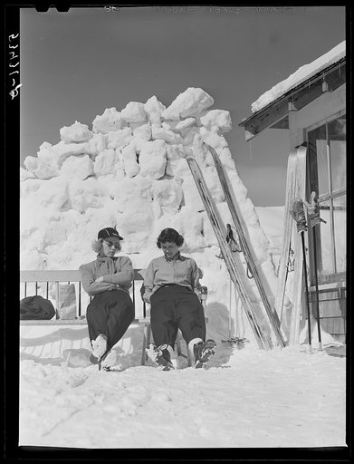 Skiers relaxing outside of lodge. North Conway, New Hampshire