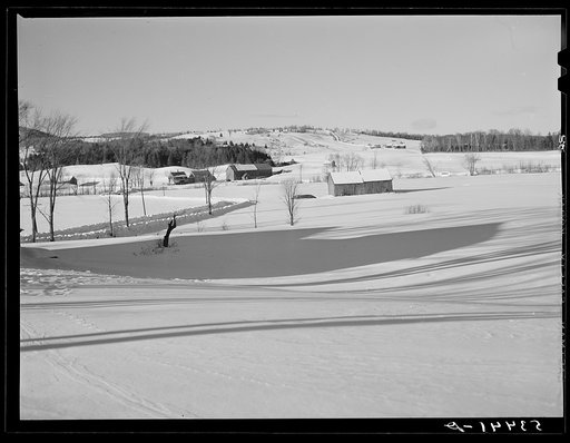 Country road and farms near Stowe, Vermont. Snowscene