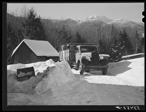 Truckload of hay being delivered at the lodge with Mount Mansfield, Smugglers Notch near Stowe, Vermont, in the distance