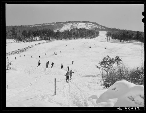Skiers on Cranmore Mountain with "ski mobile" on left. North Conway, New Hampshire
