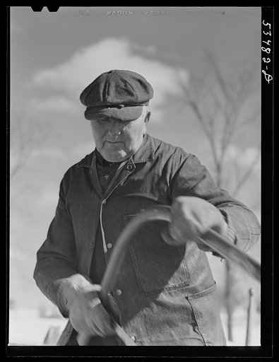 Untitled photo, possibly related to: Farmer sawing wood for winter fuel. Near Littleton, New Hampshire